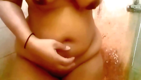 Indian woman with a nice body is showering in the bath