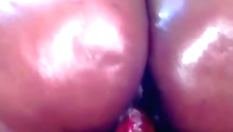 Indian woman masturbates with a dildo in front of the camera