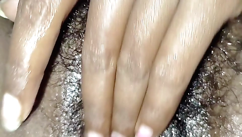Indian girl is playing with her hairy pussy in bed