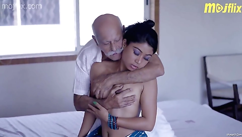 Older man gives a nice massage to a young brunette